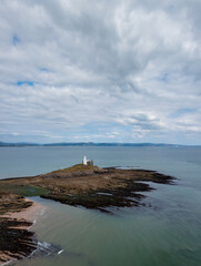 Fototapeta na wymiar view of the Mumbles Lighthouse in Swansea Bay at low tide