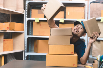 businessman with his uniform checking his parcels for delivery to customer. man doing work at his small shipping new business and new transportation delivery.