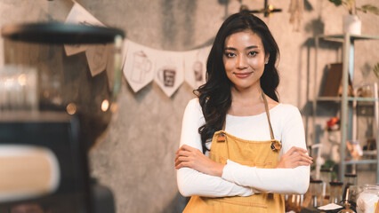 portrait of waitress handing and present bakery with smiling to customer and watching on bread. the happiness woman in coffee shop on waiter uniform and service customer.