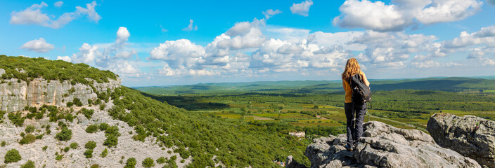 Backpacker Woman on mountain peak enjoying panoramic view of valley ( languedoc in France) - obrazy, fototapety, plakaty