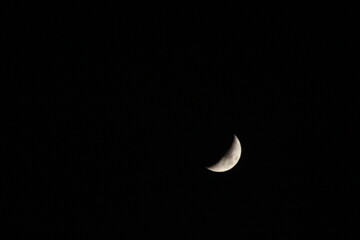 Obraz na płótnie Canvas The moon in the dark black sky