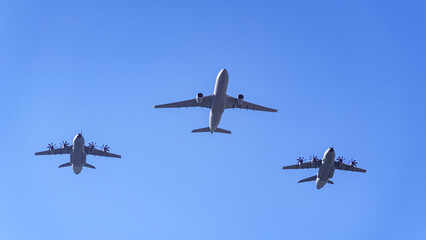 Logistic support planes flying together in the air at a military parade in Spain.