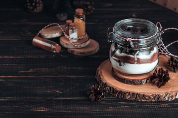 Christmas gift cookie mix in glass jar on dark wooden table