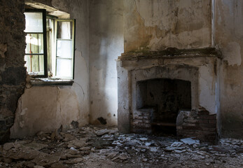 Empty deserted house room with fireplace. Abandoned collapsing places