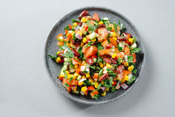 Texas salad or Texas caviar. Veggie dish with corn beans and peppers on a gray background