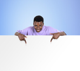 African man finger pointing at mockup banner on blue background