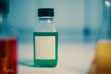 chemical bottle with blank sticker in chemistry lab