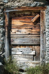 Old wooden door in alpine hut