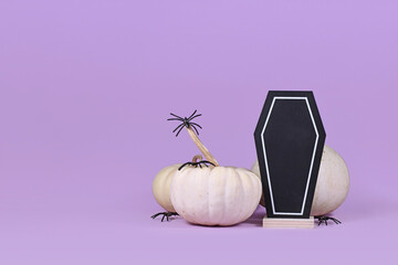 Halloween arrangement with coffin shaped chalkboard, baby boo pumpkins and spiders on purple...