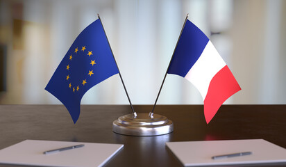 French and EU flags on table. Negotiation between European Union and France.