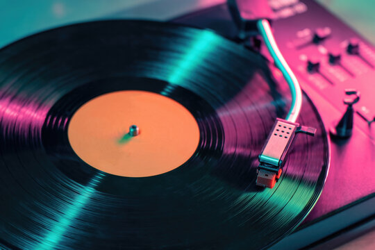 View on vintage vinyl record player playing sound from LP album.