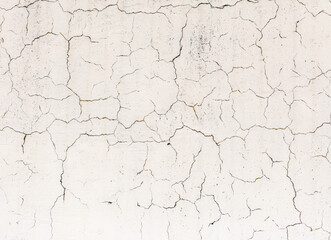 Cracked plaster on the wall of the house.