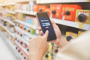 person using a phone in supermarket
