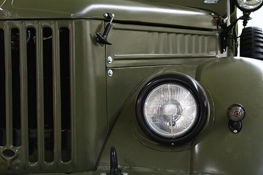 Front mask of four-wheel drive Soviet off-road military vehicle GAZ69 with round headlights and massive front grille, produced between years 1953-1972, as displayed on car expo in Nitra, Slovakia.