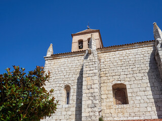 Stone wall and brick bell tower of El Salvador church in Simancas, a village in the province of Valladolid. Castilla y Leon, Spain, Europe