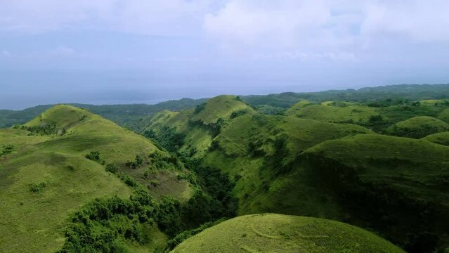landscape with green hills and clouds and sky, Nusa Penida Hills, Teletubbies  Hill, Bali, Aerial Shot Indonesia sky