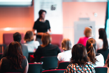 Woman giving presentation on business conference event.