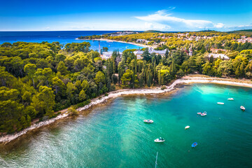 Turquoise stone beach in Rovinj aerial view, pine trees archipelago