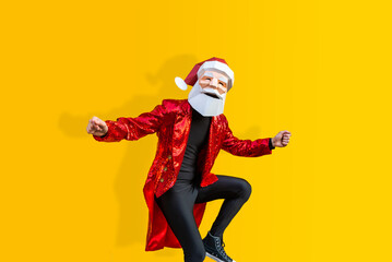 Man with funny Santa Claus low poly origami mask on colored background, colorful costume  for Christmas holiday