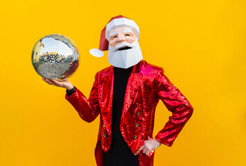 Man with funny Santa Claus low poly origami mask on colored background, colorful costume  for...