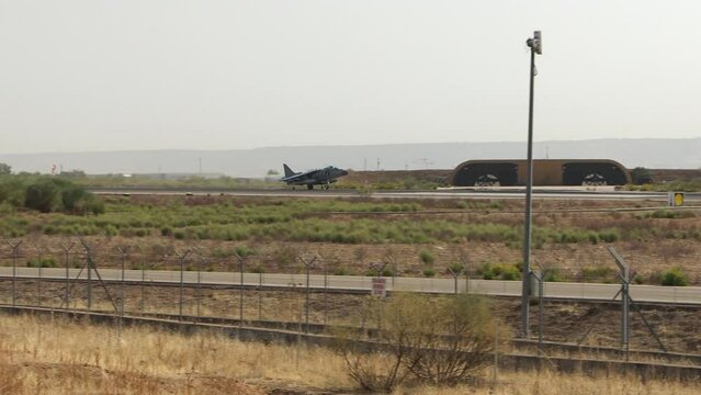 Combat aircraft landing at a military base 