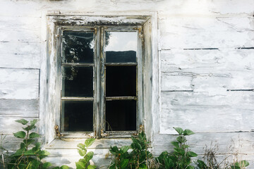 Ruined building window. Grunge destroyed facade. Abandoned home background. Peeling paint and...