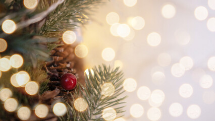 Close up of Christmas-tree, with toys, and a background of blurred lights garlands with a place for...