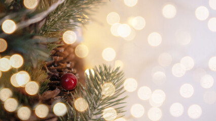 Close up of Christmas-tree, with toys, and a background of blurred lights garlands with a place for text.