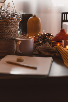 autumn photo on table with candles writing in a notebook