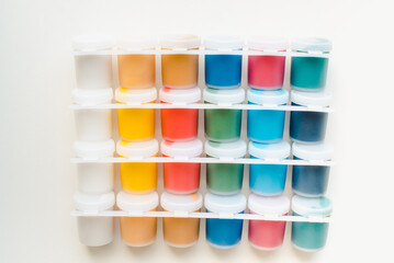 Jars with gouache on a white background. Colored gouache.