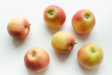 Red apples on a white background. Texture with apples.