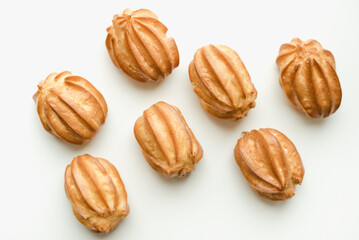 Eclairs with cream on a white background. Choux cakes on a white background.