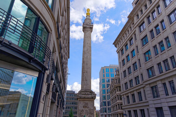Fototapeta na wymiar Monument to the Great Fire of London at City of London on a blue cloudy summer day. Photo taken August 1st, 2022, London, United Kingdom.