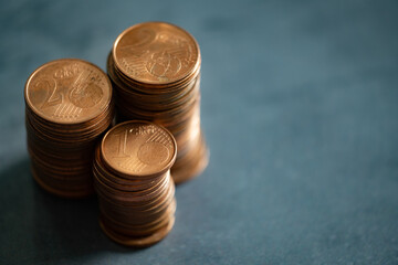Stacks of euro cents coins on metal surface. Money saving concept