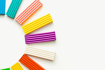 Fototapeta premium Children's plasticine on a white background. Colored plasticine.