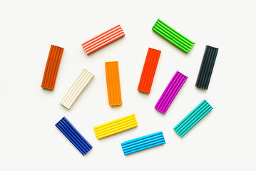 Children's plasticine on a white background. Colored plasticine.