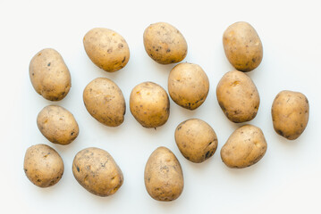 Potatoes on a wooden board. Potato on a white background. New potatoes.