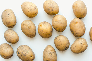 Potato on a white background. New potatoes.