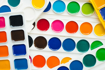 Watercolor paints and brushes. Multi-colored paints on a white background. Watercolor paints.