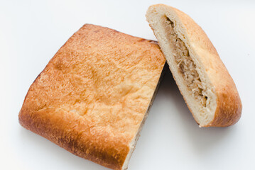 Pie with filling on a white background. Cabbage pie.