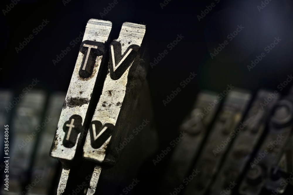 Fototapete Close-up from an old typewriter with the leters TV  - Horizontal picture with copy space.