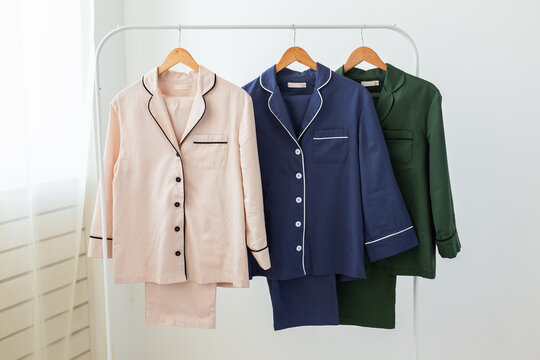 Clothing retails concept. Ladies pajamas on hangers in clothes store. Pajama in shop. Advertise, sale, fashion and shopping concept.