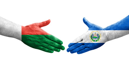 Handshake between El Salvador and Madagascar flags painted on hands, isolated transparent image.