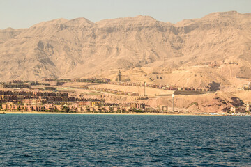 Red Sea Mountains on the horizon between the blue sky and the sea, Ain Sokhna, Suez, Egypt