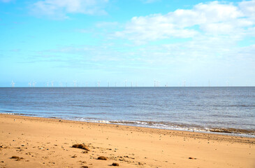 Fototapeta na wymiar Distant coastal wind farm shoal