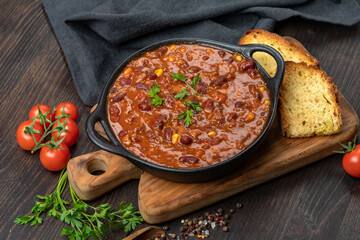 Bean and corn soup or ragout, red bean stew on a wooden background. Food Protein Vegan dish	