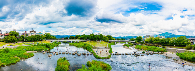 Panoramic view of Kamogawa Delta. Kyoto Kamo river -Kamogawa- river side view under dynamic blue...
