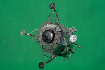 Model of the Apollo Lunar Module on a green background