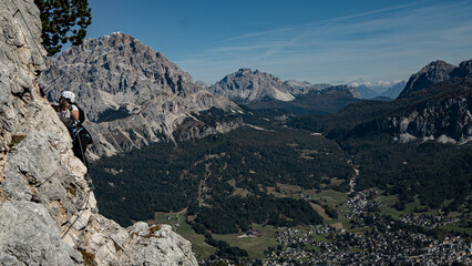 Person is doing via ferrata in dolomite's 