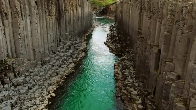 studlagil canyon aerial view drone flying between basalt rock formation icelandic nature landmark famous travel destination